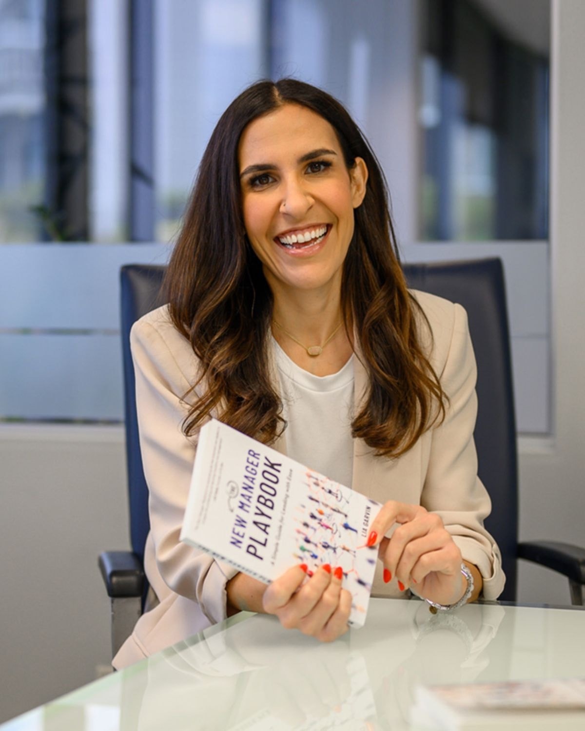 Lia Garvin with her book, The New Manager Playbook